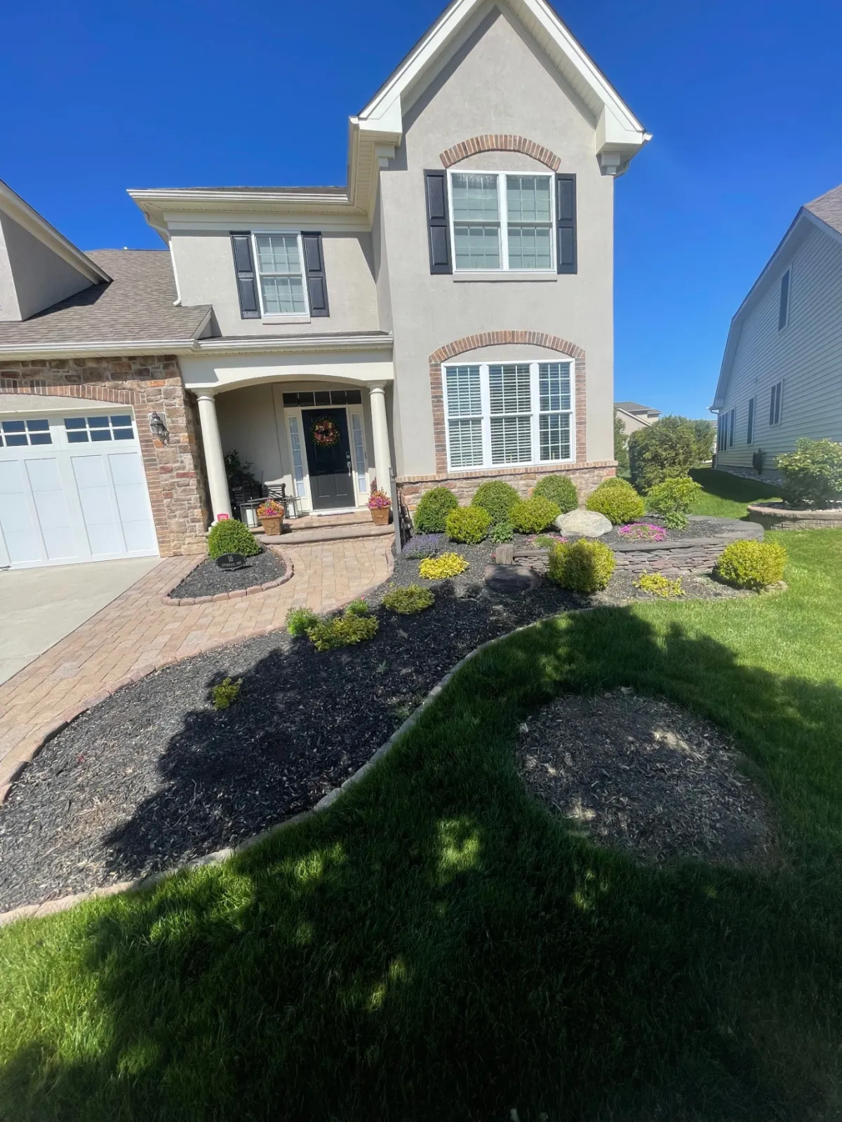 Finished front yard with fresh mulch beds and new plantings